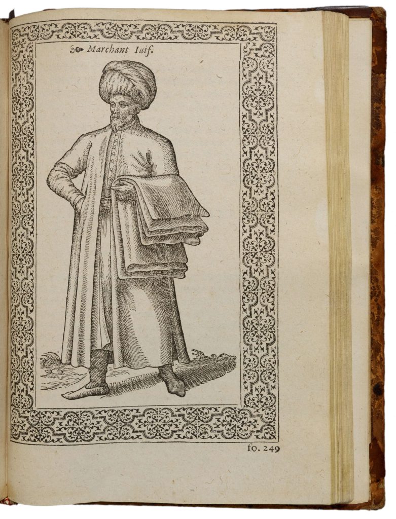 Engraving of a Jewish merchant wearing a turban and a tunic, carrying draped bolts of fabric on his arm.